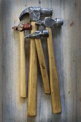 Image showing four different hammer on a wooden