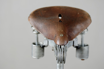 Image showing old-fashioned vintage leather bike saddle with spring