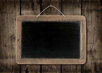 Image showing Blackboard on a dark wood wall background