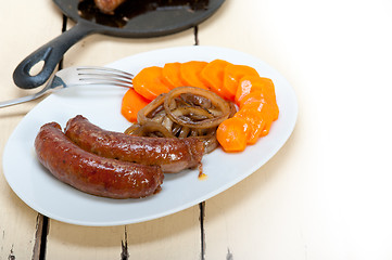 Image showing beef sausages cooked on iron skillet 