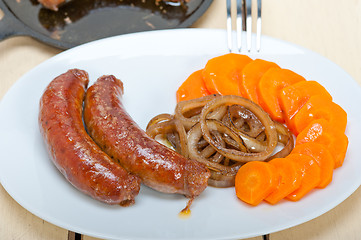 Image showing beef sausages cooked on iron skillet 