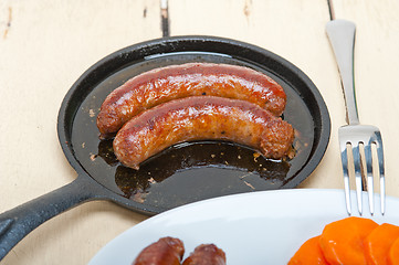 Image showing beef sausages cooked on iron skillet 