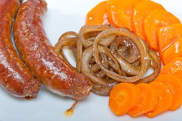 Image showing beef sausages cooked on iron skillet 