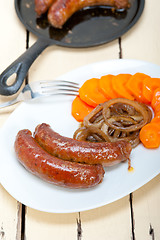 Image showing beef sausages cooked on iron skillet 