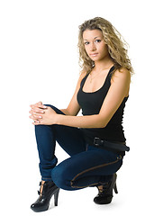 Image showing Attractive curly girl in jeans