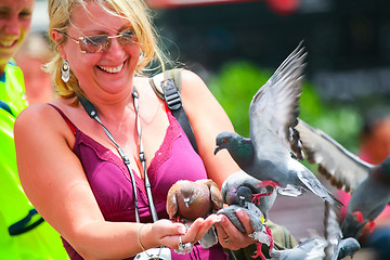 Image showing Woman holding pigeons