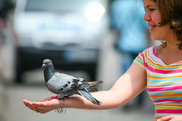 Image showing Girl holding pigeon