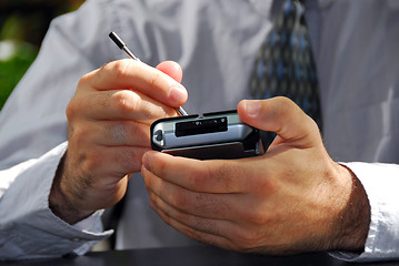 Image showing Man hands pda