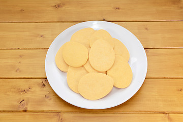 Image showing Pile of egg-shaped biscuits on a white plate
