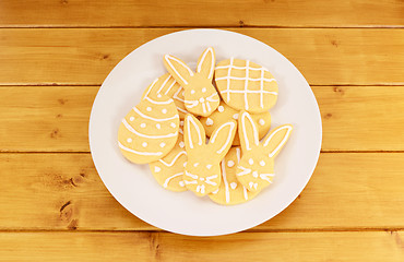 Image showing Plate full of frosted Easter cookies on a wooden table