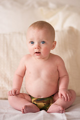 Image showing Young Blue Eyed Infant Boy Sitting Up Camo Underwear