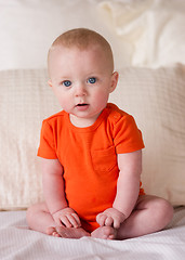 Image showing Young Blue Eyed Infant Boy Sitting up Looking at Camera