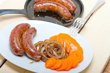 Image showing beef sausages cooked on iron skillet 