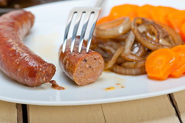 Image showing beef sausages cooked on iron skillet 