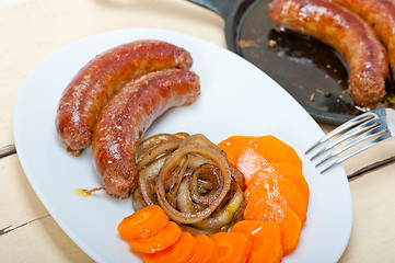 Image showing beef sausages cooked on iron skillet 