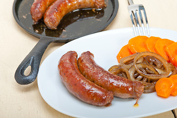 Image showing beef sausages cooked on iron skillet 