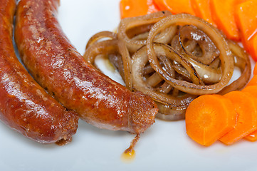 Image showing beef sausages cooked on iron skillet 