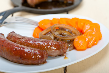 Image showing beef sausages cooked on iron skillet 