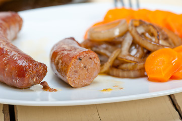 Image showing beef sausages cooked on iron skillet 