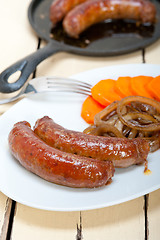 Image showing beef sausages cooked on iron skillet 