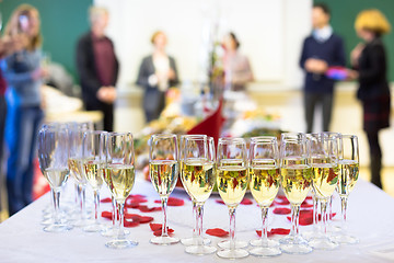 Image showing Banquet event. Waiter pouring champagne into glass.