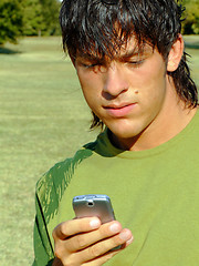 Image showing Young man with mobile