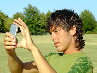 Image showing Young man with mobile