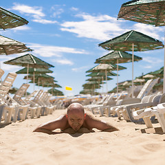 Image showing Half face of a handsome man covered with sand