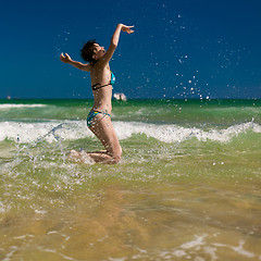 Image showing woman splashing water in the ocean