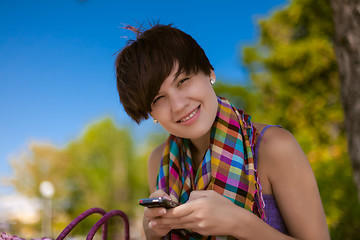 Image showing Young beautiful woman writes an SMS