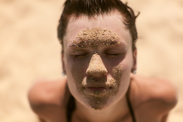 Image showing Beautiful girl with sand on face