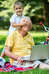 Image showing grandfather and child using laptop