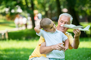 Image showing grandfather and child have fun  in park