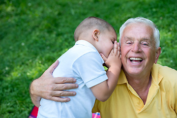 Image showing grandfather and child have fun  in park