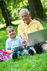 Image showing grandfather and child using laptop