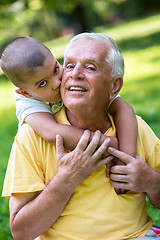 Image showing grandfather and child have fun  in park