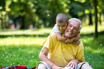 Image showing grandfather and child have fun  in park