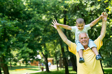 Image showing grandfather and child have fun  in park