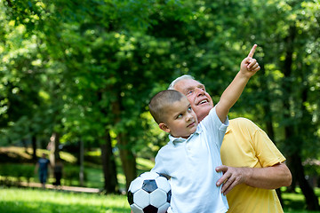 Image showing grandfather and child have fun  in park