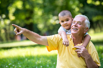 Image showing grandfather and child have fun  in park