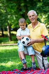 Image showing grandfather and child have fun  in park