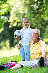 Image showing grandfather and child have fun  in park