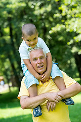 Image showing grandfather and child have fun  in park