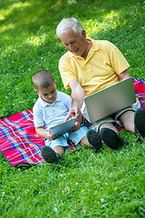 Image showing grandfather and child using laptop