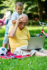 Image showing grandfather and child using laptop