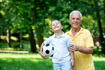 Image showing grandfather and child have fun  in park