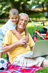 Image showing grandfather and child using laptop