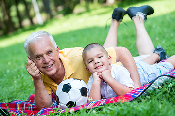 Image showing grandfather and child have fun  in park