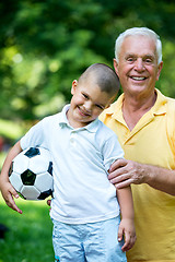 Image showing grandfather and child have fun  in park