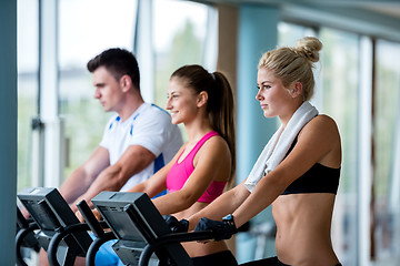 Image showing friends  exercising on a treadmill at the bright modern gym